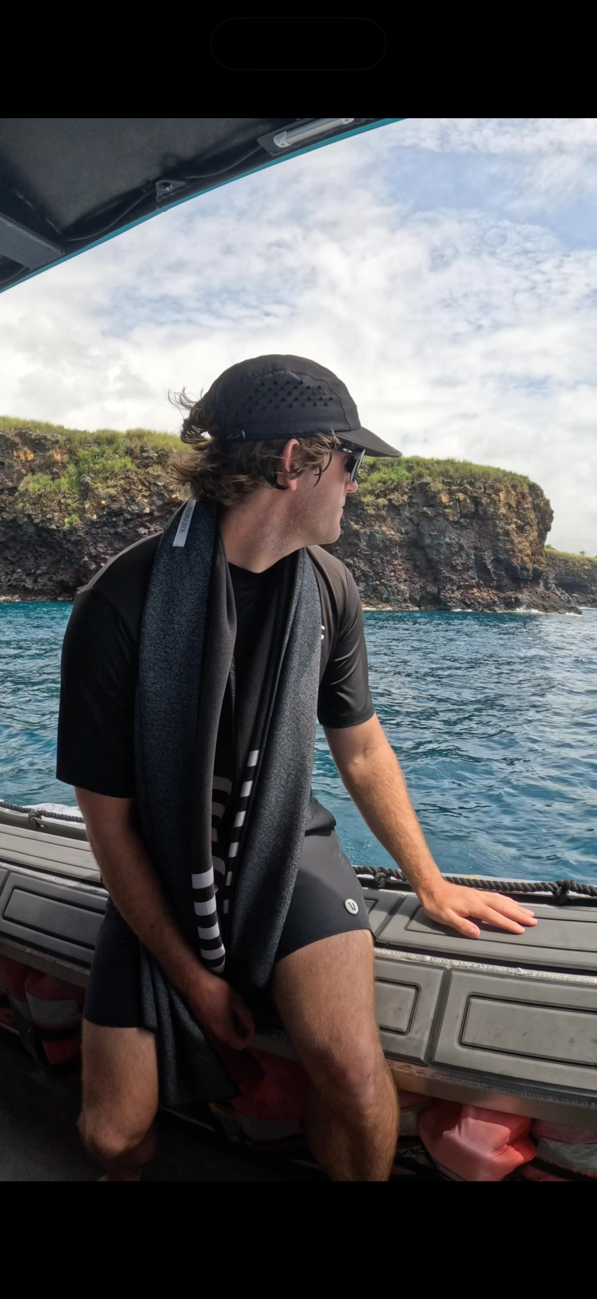 A traveler wearing snorkeling gear while sitting aboard a boat